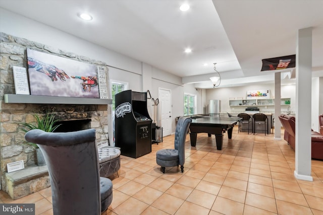 recreation room featuring light tile patterned flooring and a fireplace