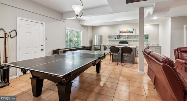 recreation room with sink and light tile patterned floors