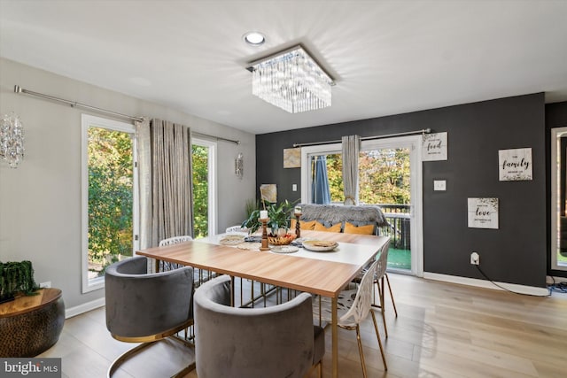 dining space with light hardwood / wood-style floors and plenty of natural light