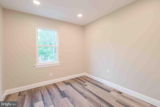 spare room featuring hardwood / wood-style floors