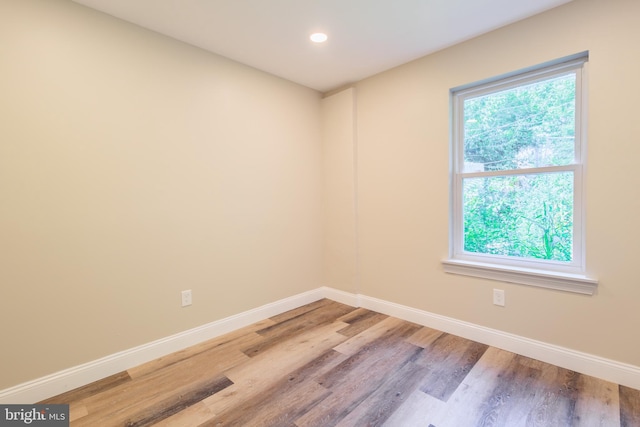 empty room with hardwood / wood-style floors