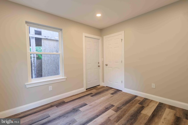 spare room with hardwood / wood-style floors