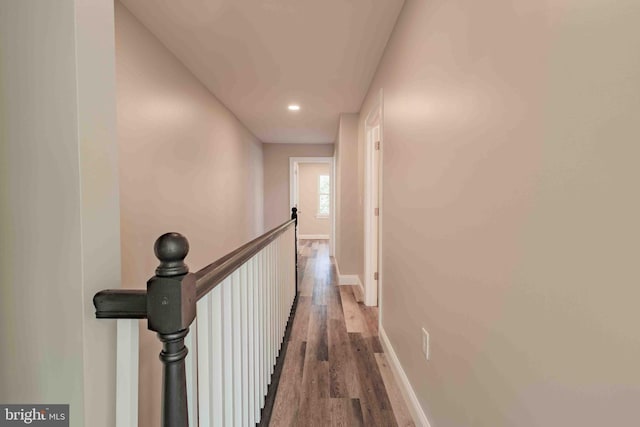 corridor with hardwood / wood-style floors