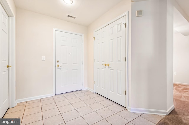 foyer entrance with light tile patterned flooring