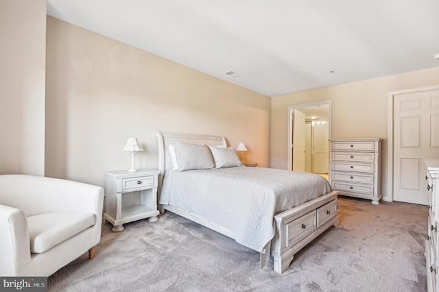 carpeted bedroom featuring ensuite bathroom