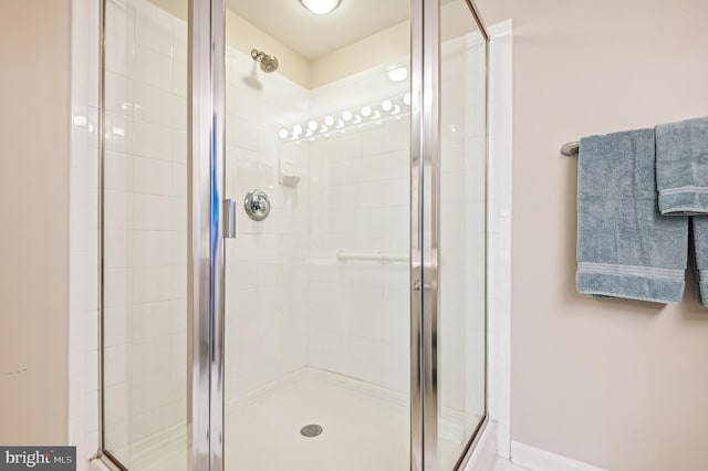 bathroom with a shower with door