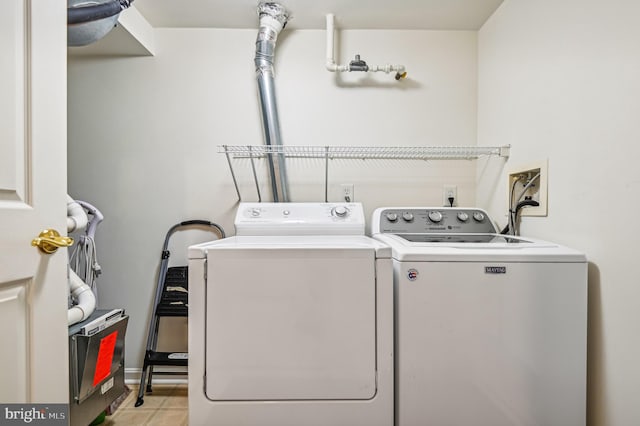 clothes washing area featuring washing machine and clothes dryer