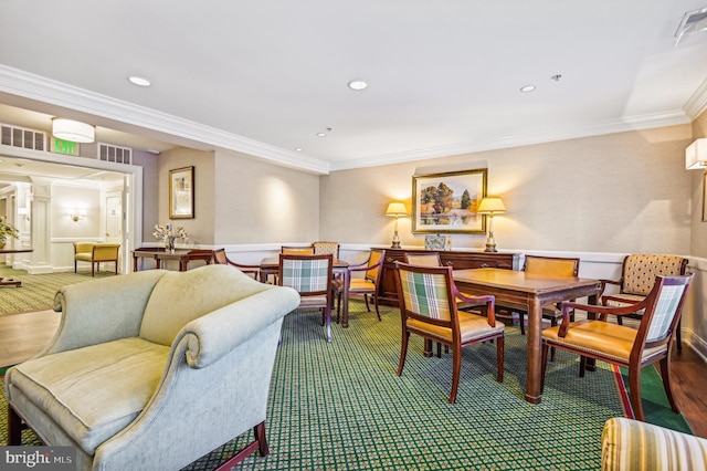 dining area featuring wood-type flooring and ornamental molding