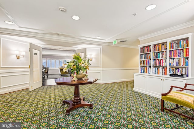 sitting room with crown molding and carpet flooring