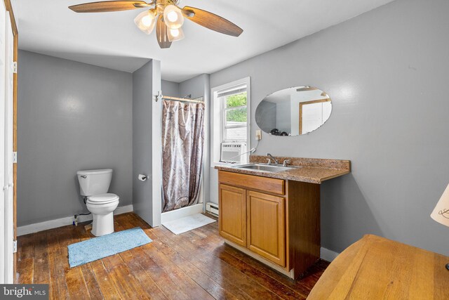 bathroom featuring ceiling fan, vanity, wood-type flooring, a shower with curtain, and toilet