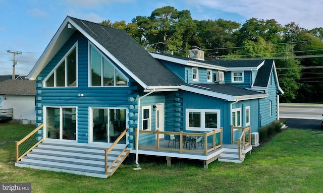 rear view of house featuring a wooden deck, ac unit, and a yard