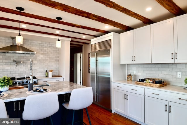 kitchen featuring white cabinetry, pendant lighting, and appliances with stainless steel finishes