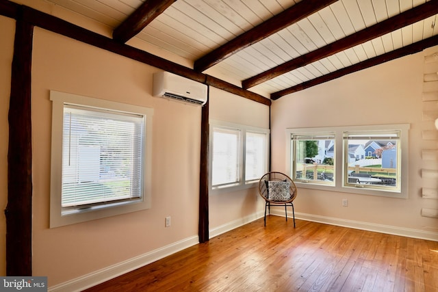 empty room featuring hardwood / wood-style floors, wooden ceiling, a wall mounted AC, and lofted ceiling with beams