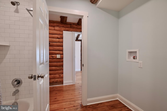 washroom with hookup for a washing machine, light wood-type flooring, and log walls