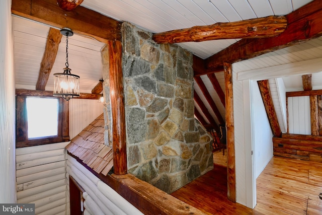 interior space with a chandelier, vaulted ceiling with beams, light hardwood / wood-style floors, and wood ceiling