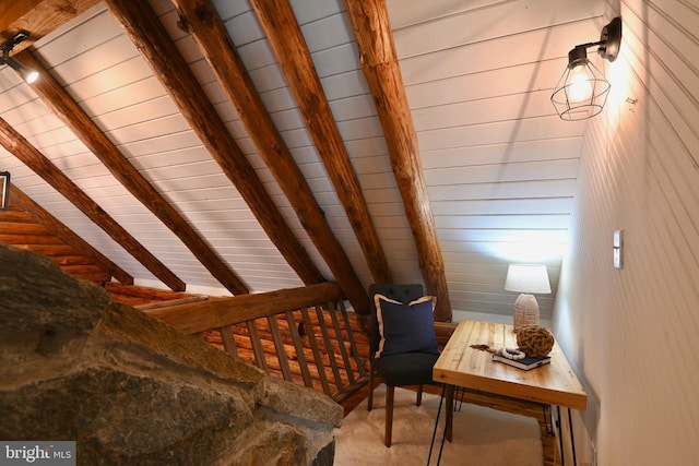 unfurnished room with wood walls, wooden ceiling, and vaulted ceiling with beams