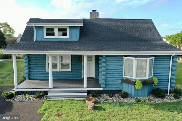 view of front of house with a porch and a front lawn