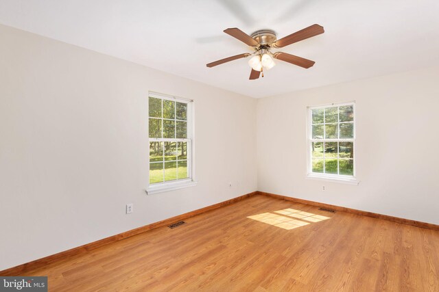 empty room with light wood-type flooring and ceiling fan