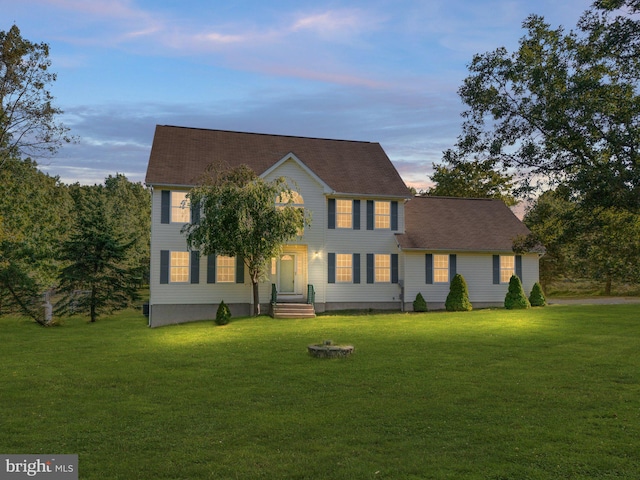 colonial home featuring a lawn