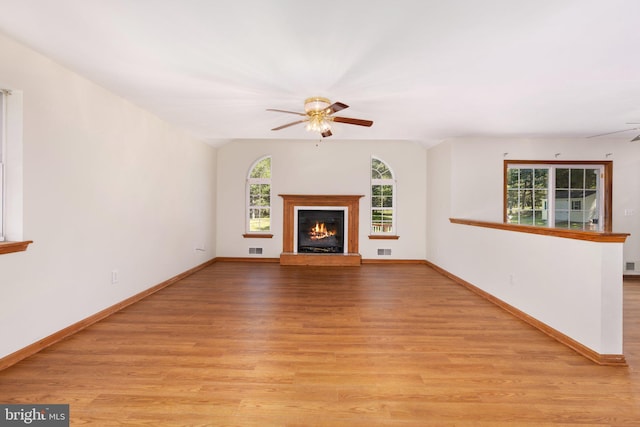 unfurnished living room with light hardwood / wood-style flooring and ceiling fan