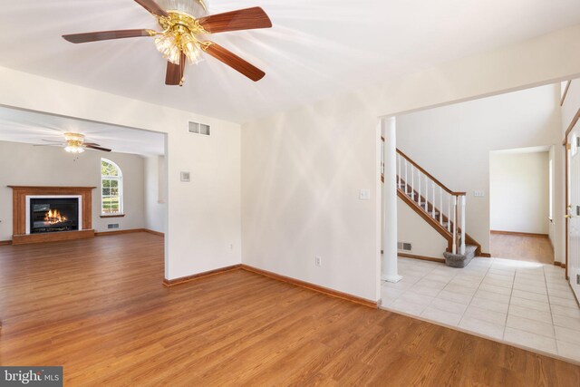 unfurnished living room with light hardwood / wood-style floors and ceiling fan