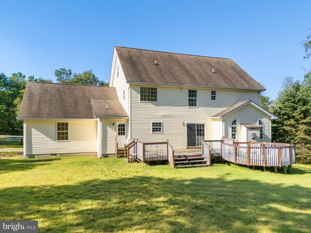 back of house with a lawn and a deck