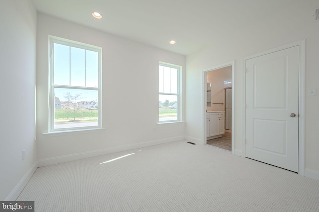 unfurnished bedroom with recessed lighting, baseboards, visible vents, and light carpet