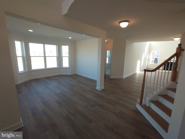 unfurnished living room featuring dark hardwood / wood-style flooring