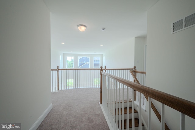 hall featuring visible vents, carpet floors, baseboards, an upstairs landing, and recessed lighting