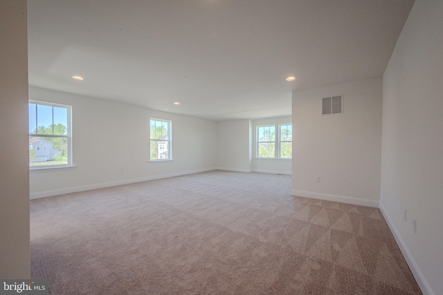 unfurnished room featuring recessed lighting, baseboards, visible vents, and light carpet
