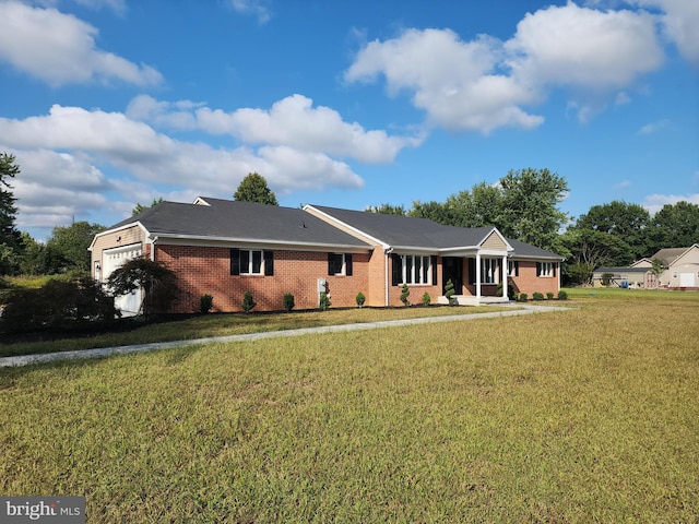 ranch-style house featuring covered porch and a front yard