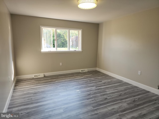 unfurnished room featuring dark hardwood / wood-style flooring