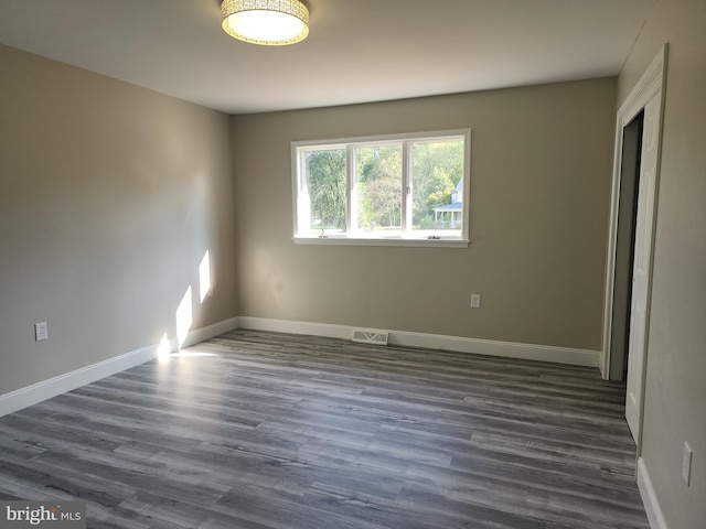 spare room featuring dark hardwood / wood-style floors