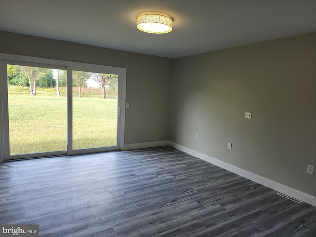 unfurnished room with dark hardwood / wood-style floors