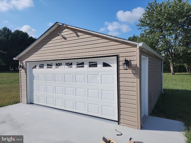 garage with a lawn and wooden walls