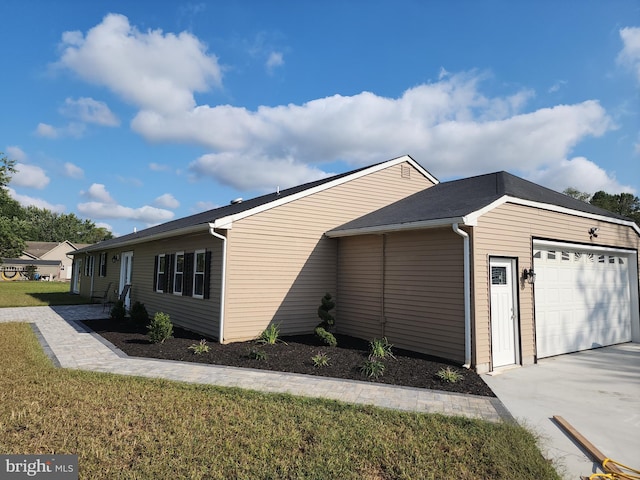 view of home's exterior with a lawn and a garage