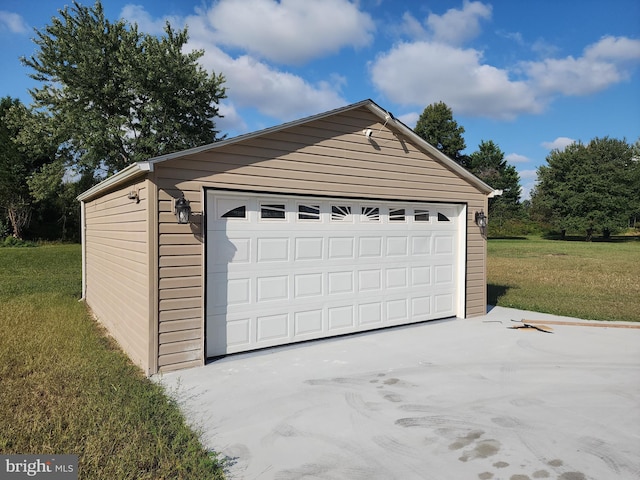 garage featuring a yard and wooden walls