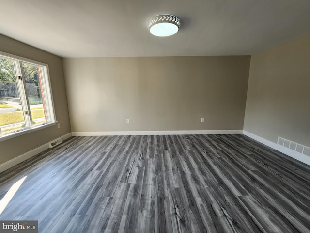 spare room featuring dark hardwood / wood-style floors