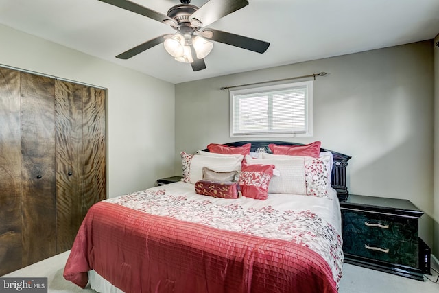 bedroom featuring ceiling fan and light carpet