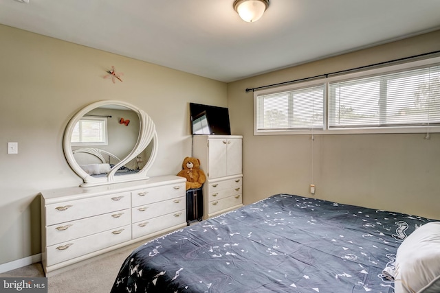 bedroom featuring light colored carpet