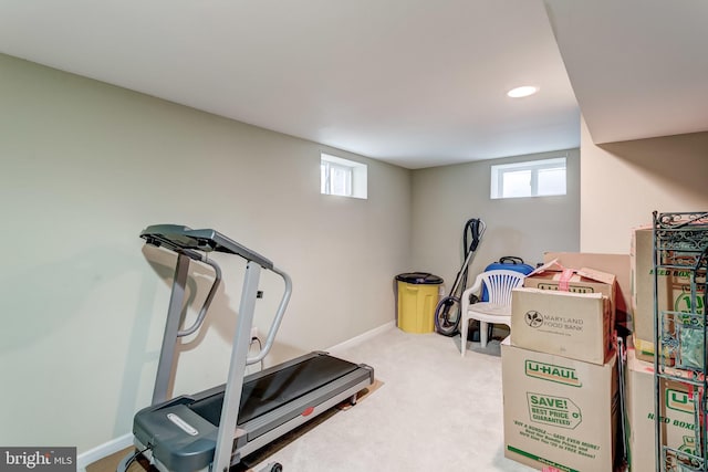 exercise room with a healthy amount of sunlight and light carpet