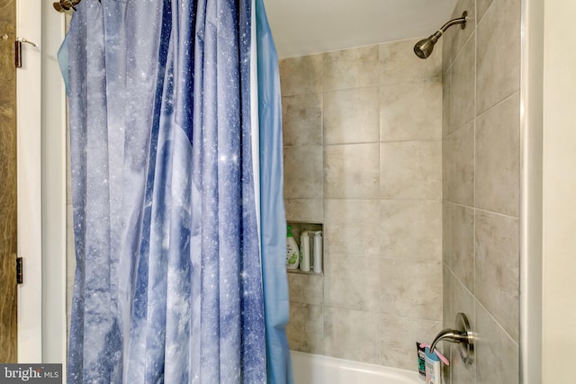 bathroom featuring shower / bathtub combination with curtain