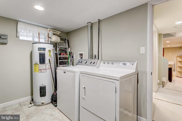 laundry area with washing machine and dryer and electric water heater