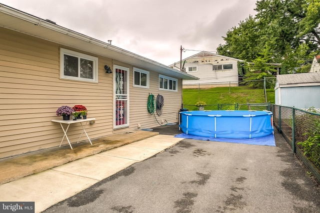 exterior space featuring a storage shed and a patio area