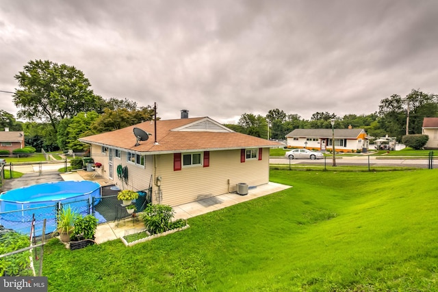 back of house with a lawn