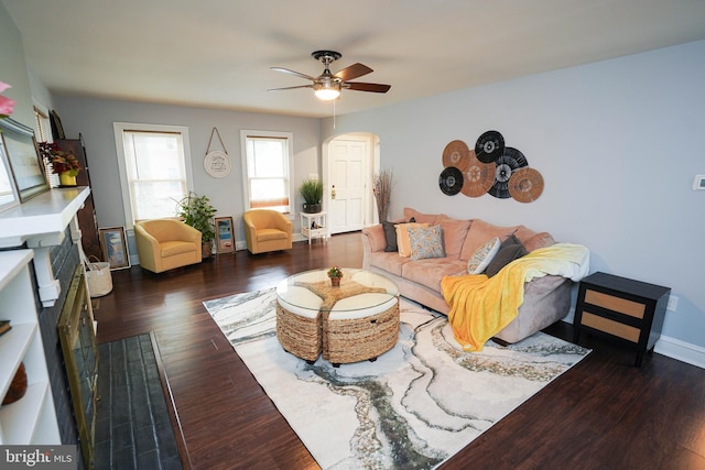 living room with ceiling fan and dark hardwood / wood-style flooring