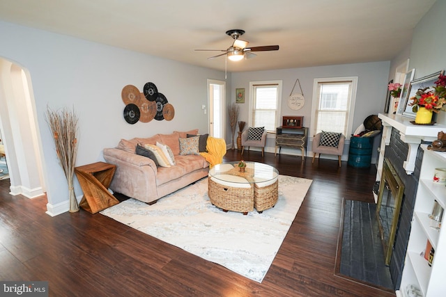 living room featuring dark hardwood / wood-style floors and ceiling fan