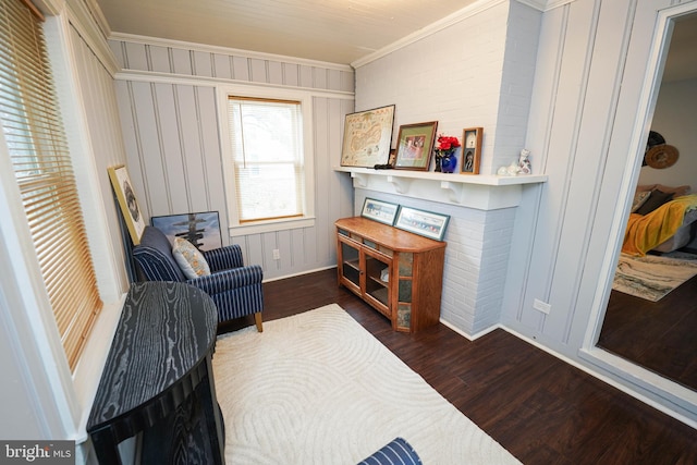 sitting room with dark hardwood / wood-style flooring and crown molding