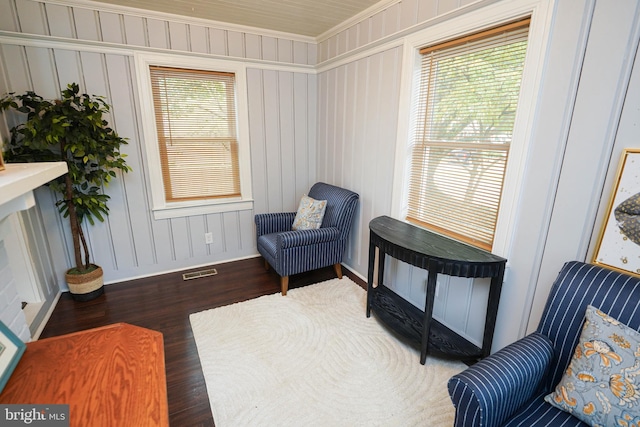 living area featuring dark hardwood / wood-style floors and crown molding