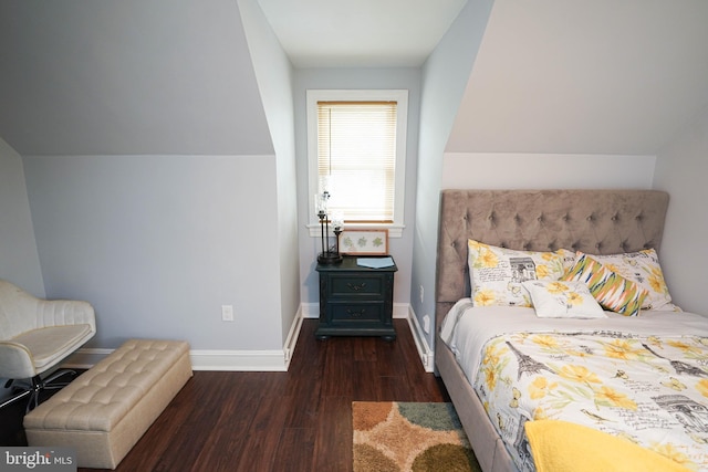 bedroom featuring vaulted ceiling and dark wood-type flooring